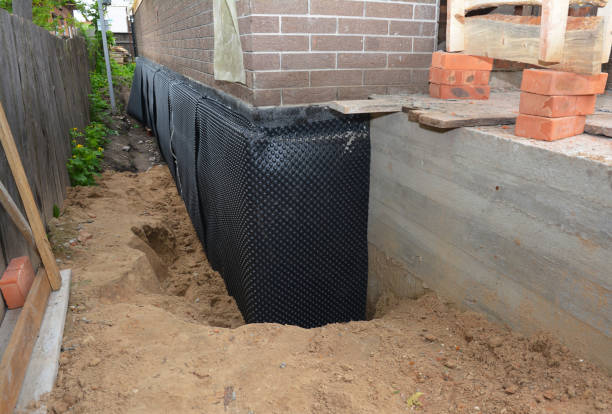 Happy homeowners after waterproofing job in Manitou Beach